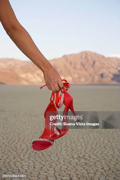 woman holding high heels, close-up (focus on hands) - heels hand stock-fotos und bilder