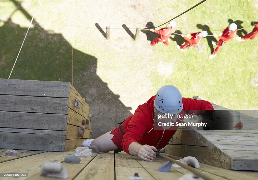 Man Climbing Obstacle Wall High-Res Stock Photo - Getty Images