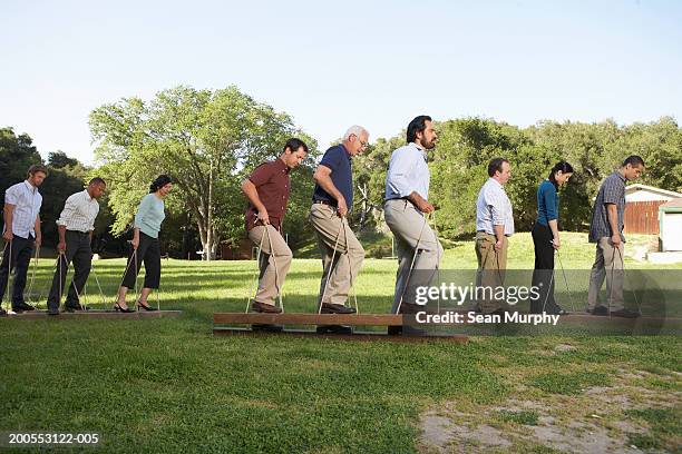 business colleagues doing team building exercises - team building stock pictures, royalty-free photos & images