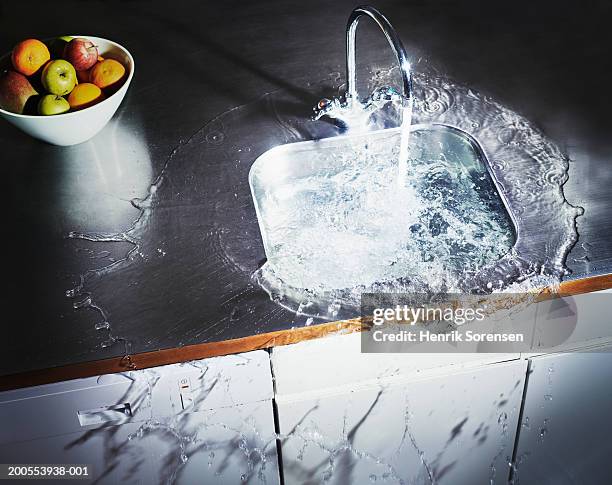 water overflowing in kitchen sink, elevated view - water plug stock pictures, royalty-free photos & images