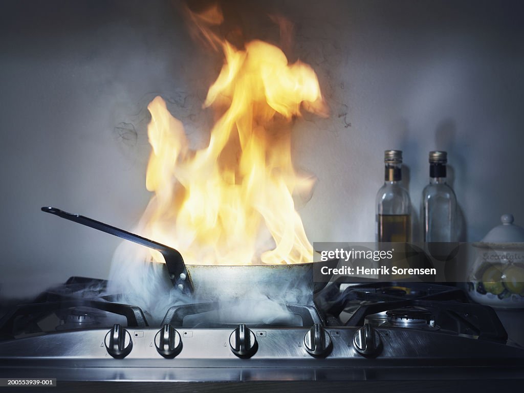 Burning frying pan in kitchen