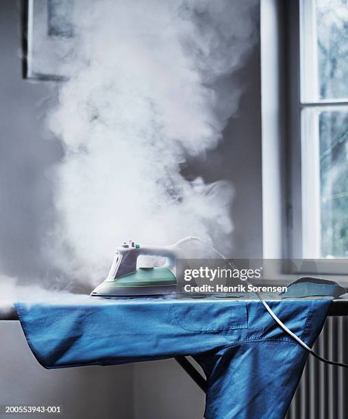 smoke coming out from unattended iron - ignorance foto e immagini stock