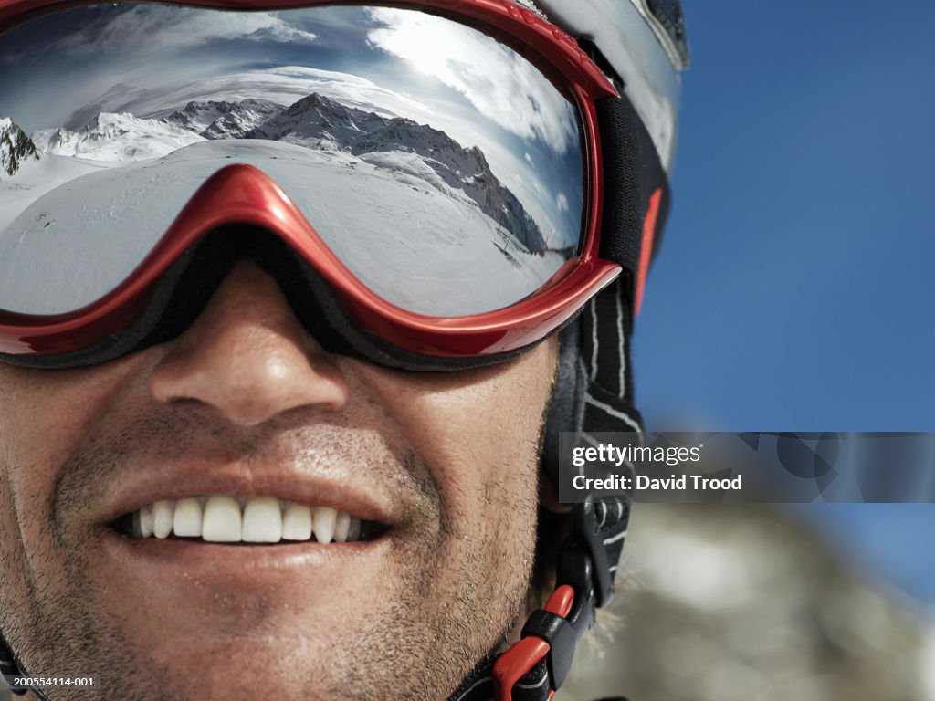 Man wearing ski goggles, smiling, close-up