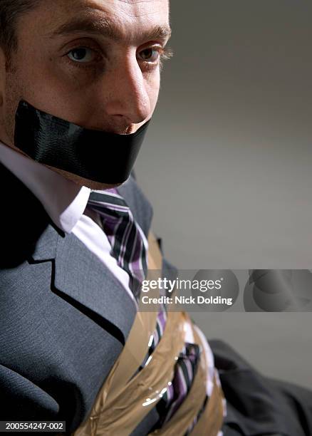 businessman bound and gagged, close up, portrait - hostage stockfoto's en -beelden