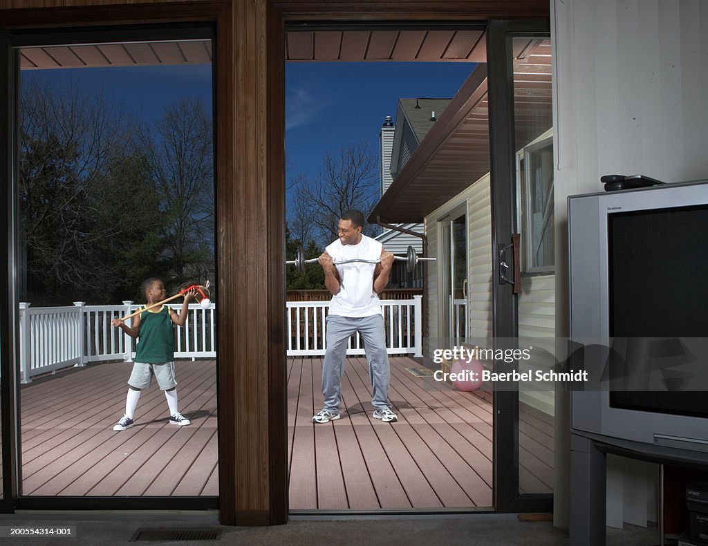 Father and son (4-5) exercising