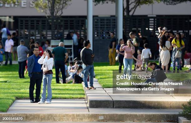 Woman holds her face as she waited with others outside Lakewood Church on Sunday, Feb. 11 in Houston, after a reported shooting during a Spanish...