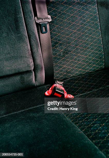 close-up on car backseat with used condom over seatbelt - préservatif photos et images de collection