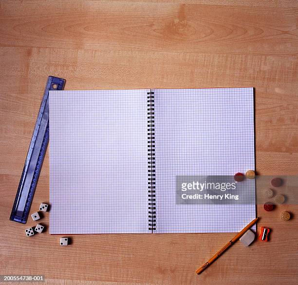 open exercise book, with ruler, sweets and dice on wooden desk, overhead view - ruler desk stock pictures, royalty-free photos & images