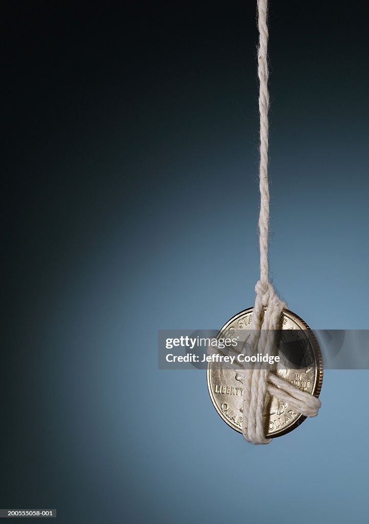 Coin Wrapped With String Suspended In Air Closeup High-Res Stock Photo ...