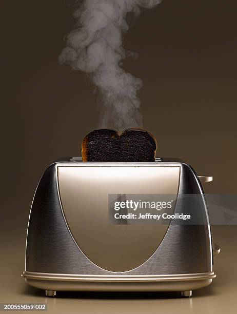 toaster with smoking burned toast - toaster fotografías e imágenes de stock