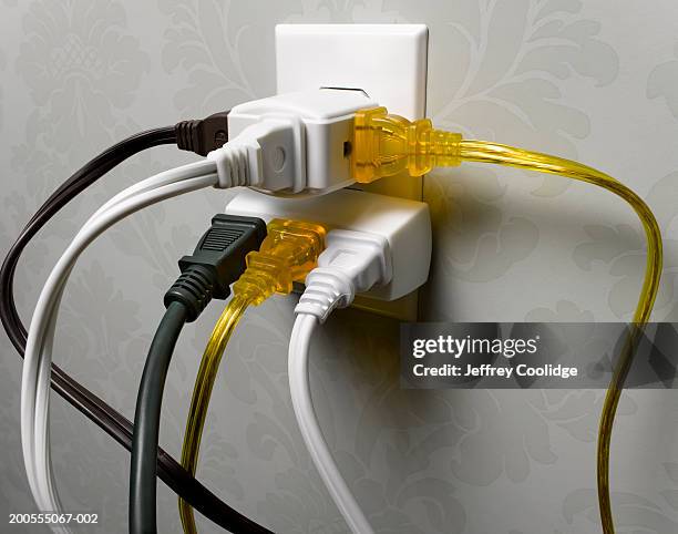 electrical wall outlet overloaded with plugs, close-up - electrical overload bildbanksfoton och bilder