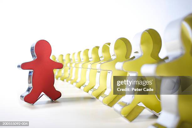 yellow pastry cutters in row with red one beside, differential focus - cookie cutter stock pictures, royalty-free photos & images