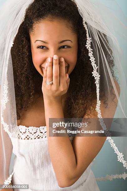 teenage girl (16-17) wearing veil and wedding dress, laughing - naughty bride fotografías e imágenes de stock