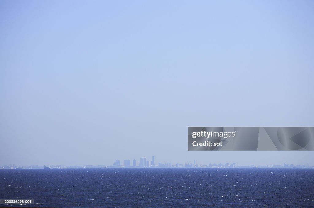 Japan, Tokyo skyline in distance over ocean