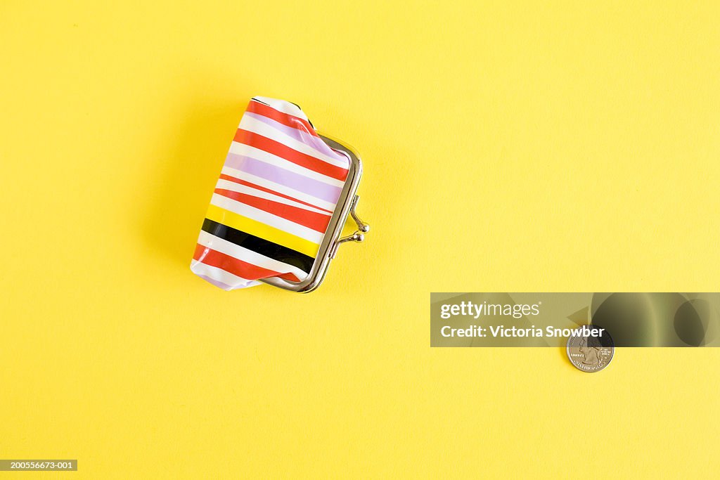 Coin and purse, close-up, overhead view