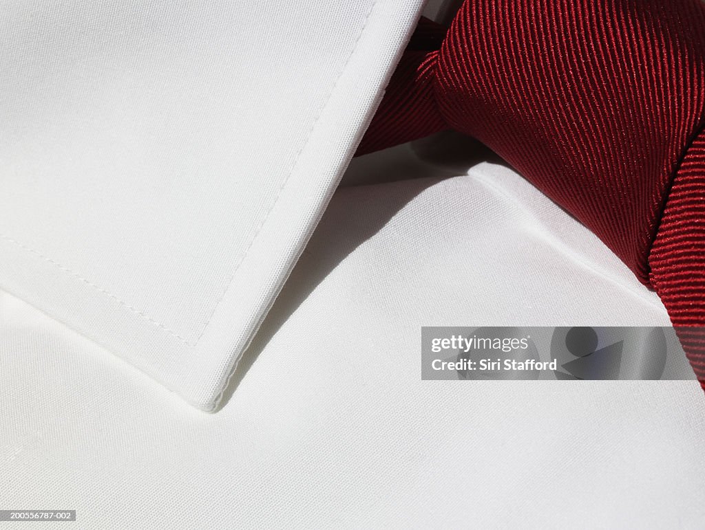 Red tie on white shirt, close-up