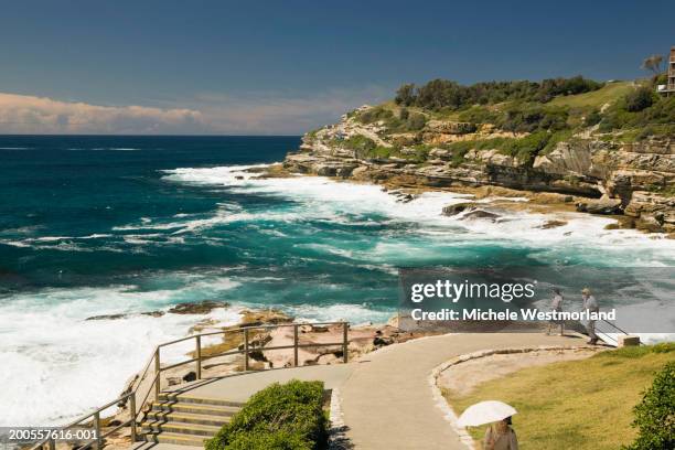 australia, sydney, bondi beach, two people walking, elevated view - bondi beach walk stock pictures, royalty-free photos & images