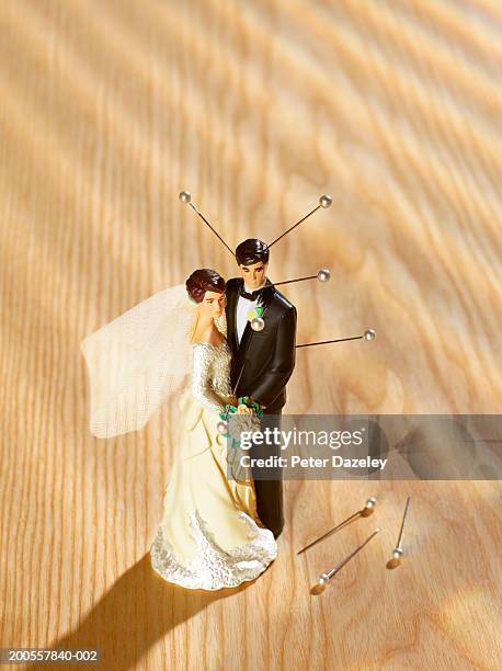 bride and groom figurine with sticking out pins, high angle view - voodoo doll stock pictures, royalty-free photos & images