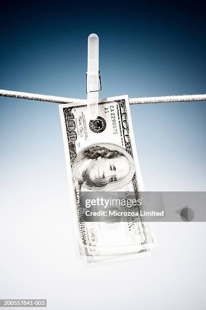 one hundred us dollar note hanging on clothes line - microzoa stock pictures, royalty-free photos & images