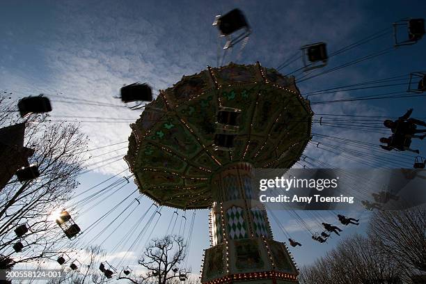 Children fly through the sky in a swing ride at the Jardin d'Acclimatation, March 17, 2006 in Paris, France. Half the world's population now lives in...