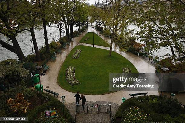 Couple takes a stroll through the Square du Vert-Galant, on the western tip of ele de la Cite in the Seine, April 16, 2006 in Paris, France. The...