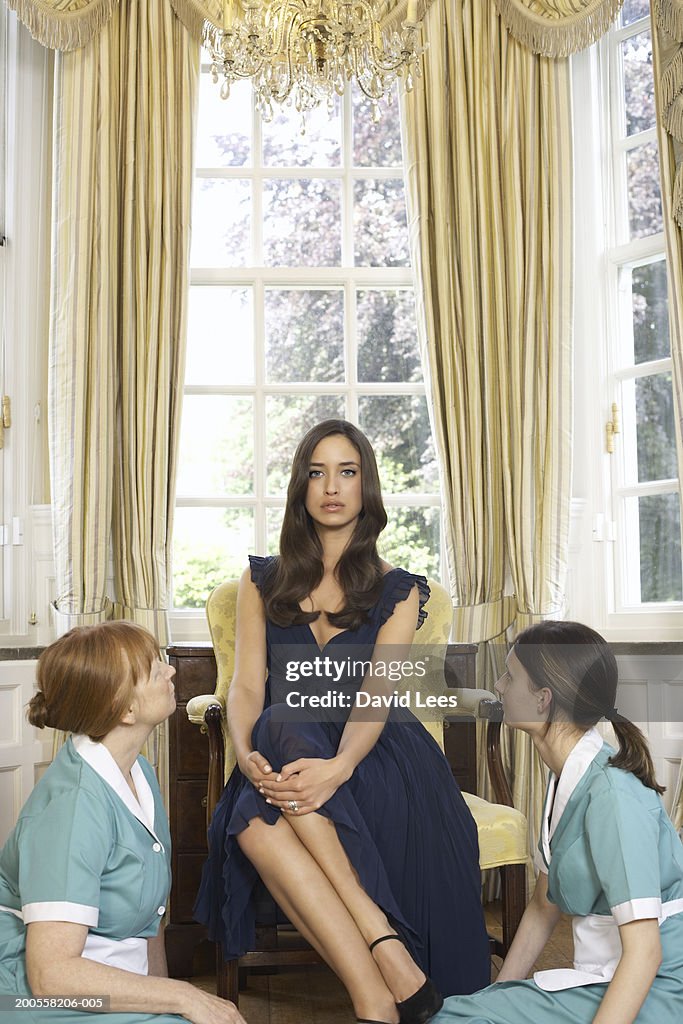 Young woman sitting with maids