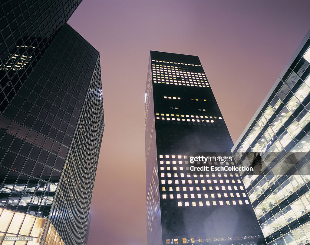 France, Paris, coffice buildings at night, low angle view (long exposure)