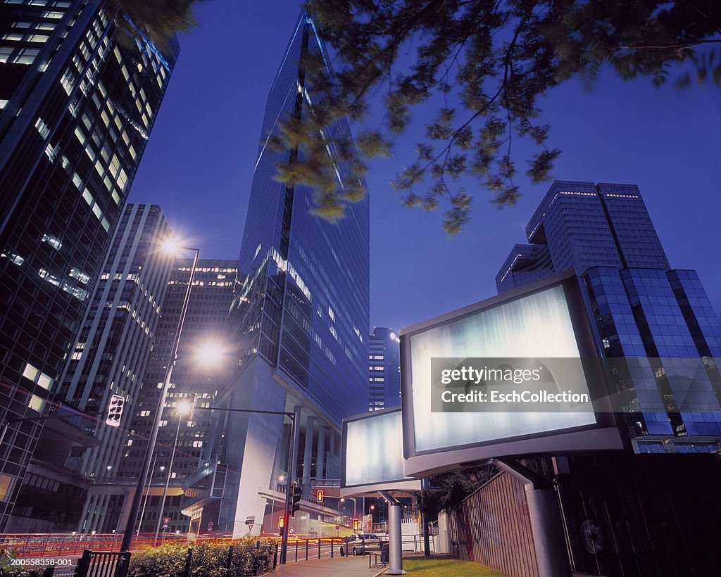 Illuminated billboards in a modern business district, low angle view
