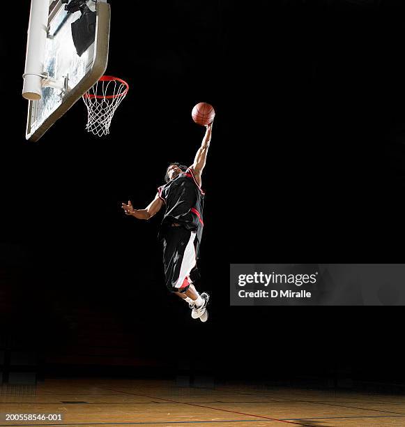 basketball player dunking ball, low angle view - slam dunk stock pictures, royalty-free photos & images