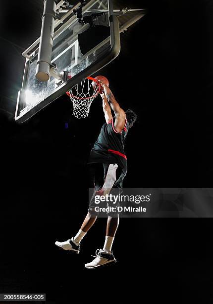 basketball player slam dunking ball - basketball player stock pictures, royalty-free photos & images
