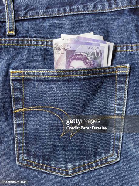 pound notes sticking out of back pocket of jeans, close-up - jean pocket stock pictures, royalty-free photos & images