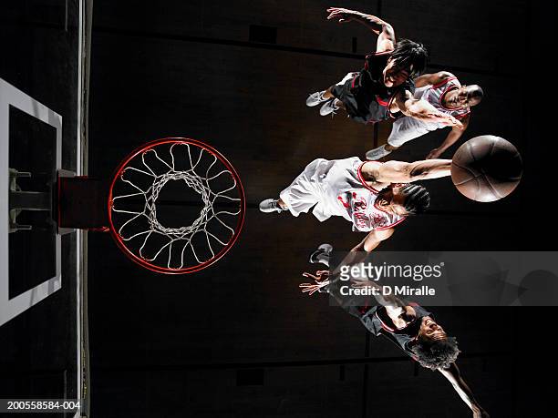 basketball player dunking ball over opponents - basketball net stock pictures, royalty-free photos & images