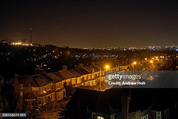 illuminated street with alexandra palace on hill - london houses stock-fotos und bilder