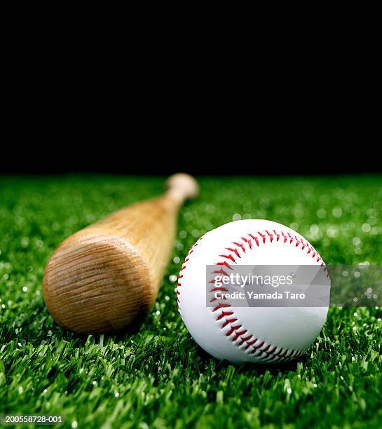 baseball and bat on grass - baseball bat stock pictures, royalty-free photos & images
