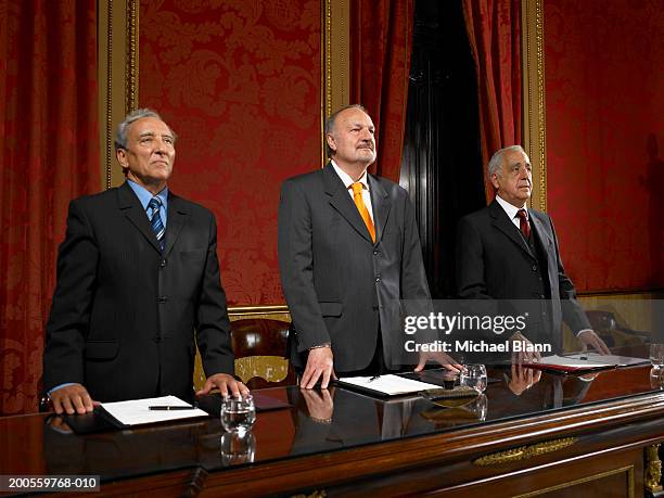 senior men standing at conference table - government accountability office stock pictures, royalty-free photos & images