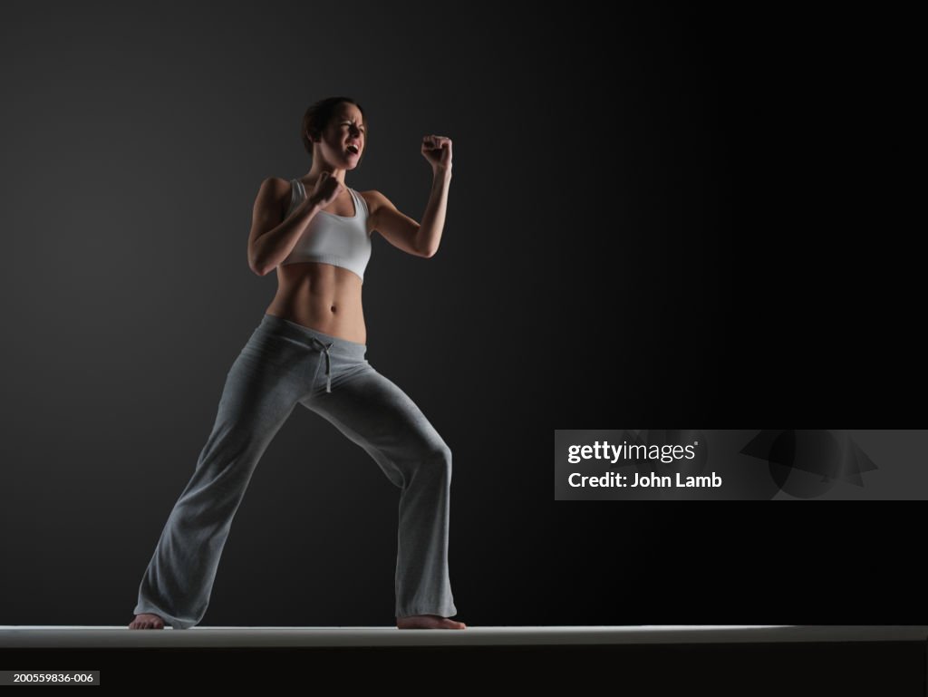 Young woman practising karate, close-up