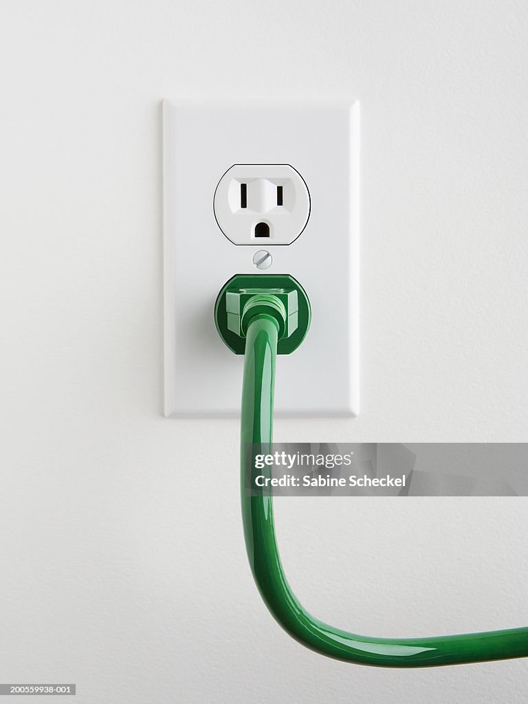 Plug Socket With Green Power Cable On Wall Closeup High-Res Stock Photo -  Getty Images