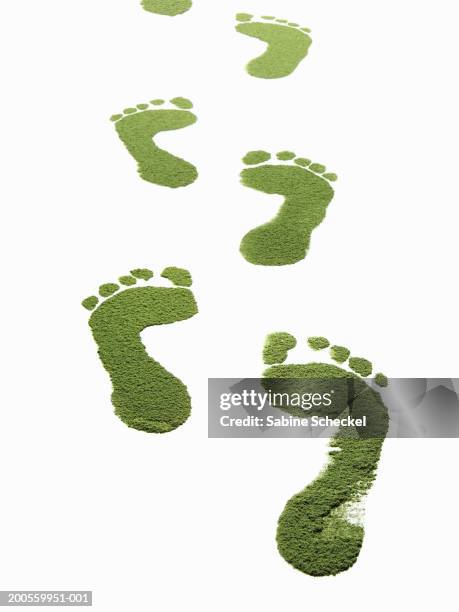 green foot prints against white background, close-up - green footprint stock pictures, royalty-free photos & images