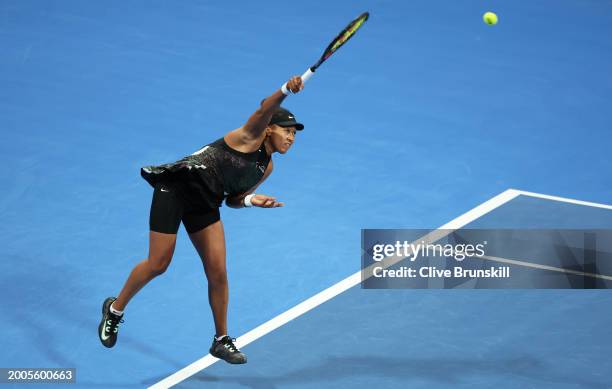 Naomi Osaka of Japan serves against Caroline Garcia of France in their first round match during the Qatar TotalEnergies Open, part of the Hologic WTA...