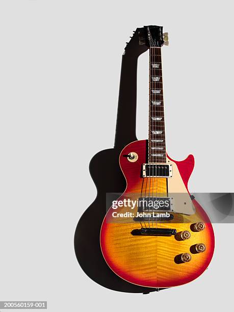 electric guitar against white background, close-up - electric guitar stock-fotos und bilder