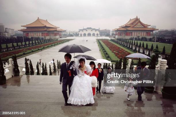 Taiwan,Taipei,wedding party with umbrellas at Chiang Kai Shek Memorial.