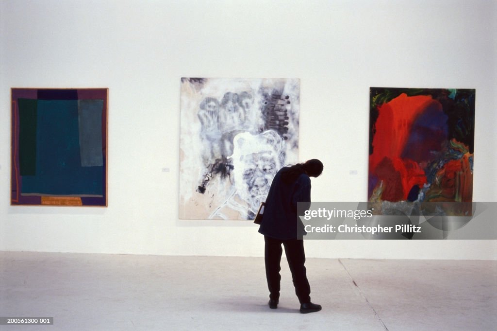 UK, London, Atlantis Gallery, person looking at artwork, rear view