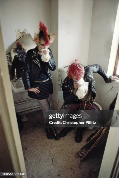 London, Brixton Glue sniffing punks inhaling intoxicants in public toilet.