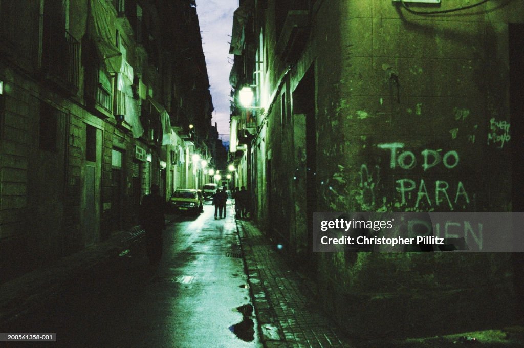 Spain, Barcelona, Barrio Chino, view down alley with grafitti