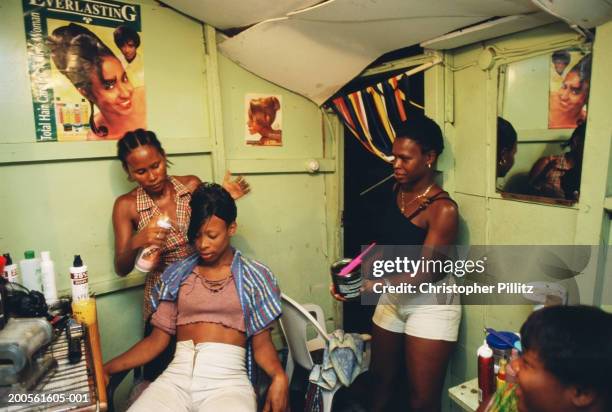 Jamaica, Kingston city, hairdresser and clients in hair salon.