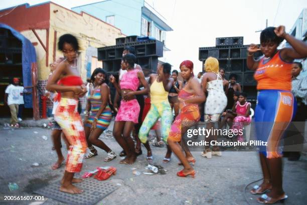 Jamaica, Kingston, group of people dancing in street, blurred motion.
