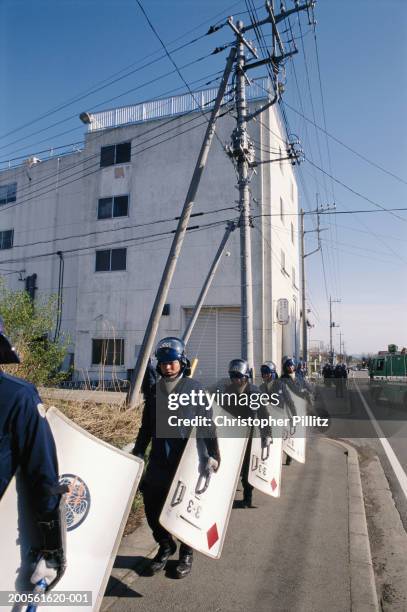 Japan, Police surrounding headquarters of Aum Shinrikyo religious sect.