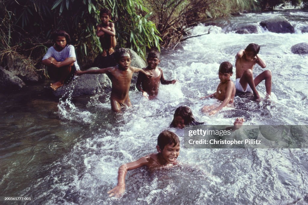 Philippines, children (8-13) bathing in river