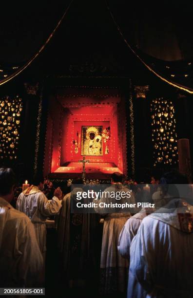 Poland, Czestochowa, Jasna Gora Monastery, pilgrimage to Black Madonna People in church in front of Virgin Mary portrait, rear view.