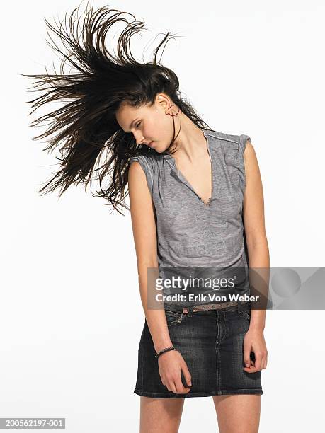 young woman head banging - headbanging stock pictures, royalty-free photos & images